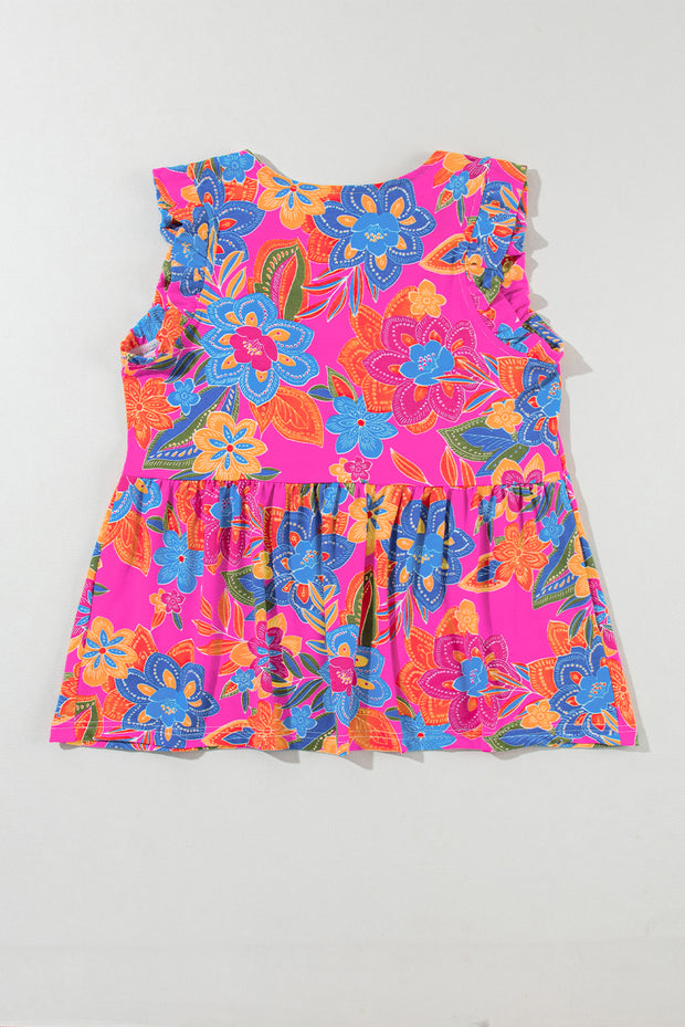 a pink dress with blue and orange flowers on it