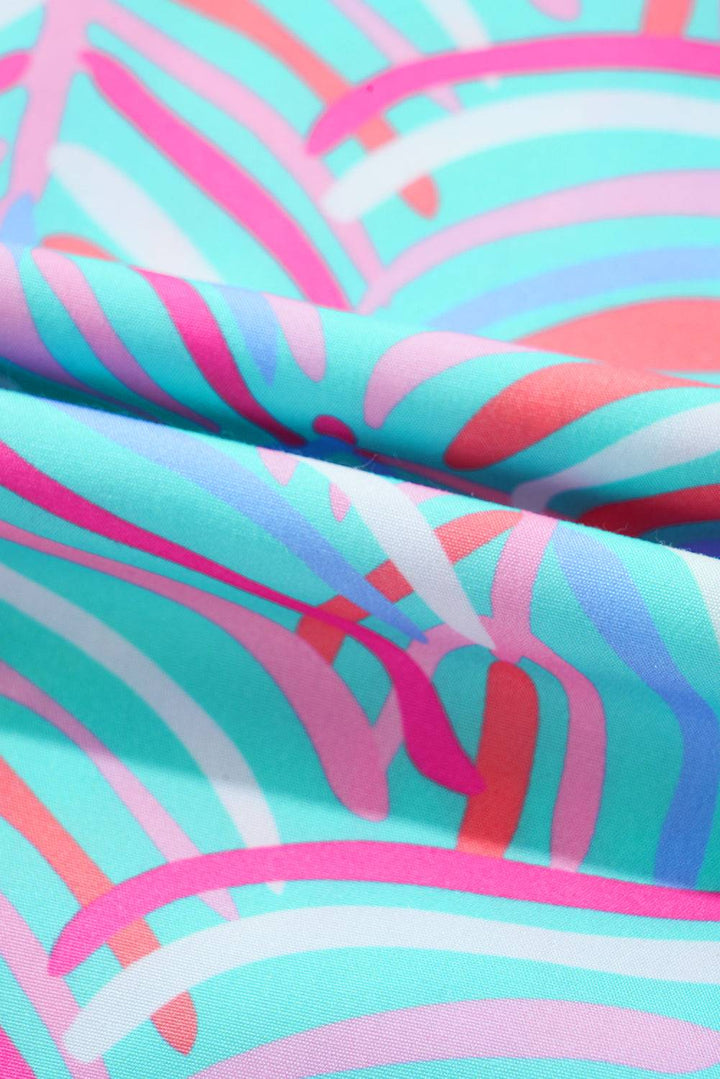 a close up of a pink, blue, and green abstract print fabric