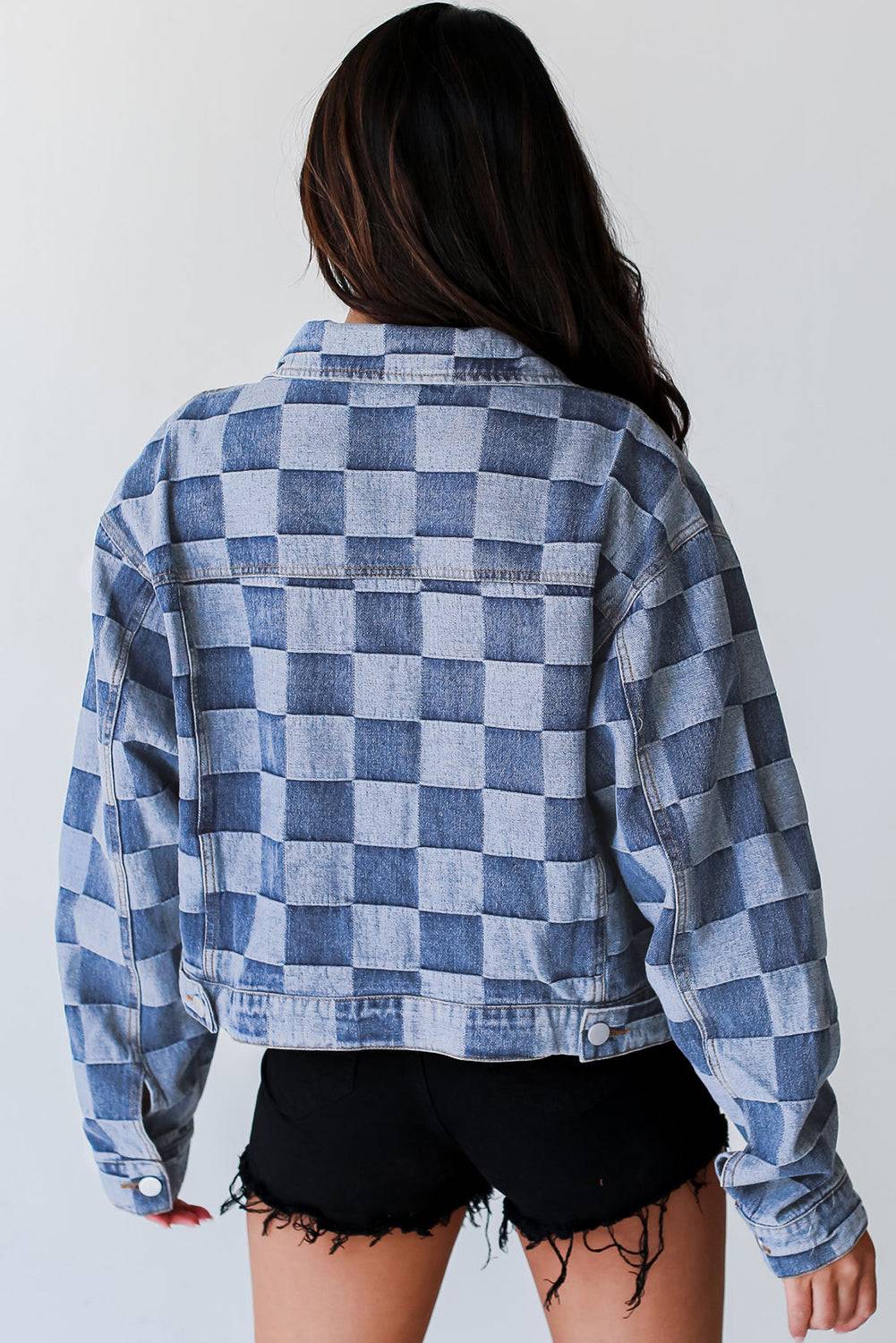 Back view of light blue checkered patchwork denim jacket, perfect for fall casual wear. Available now at Faith & Co. Boutique.
