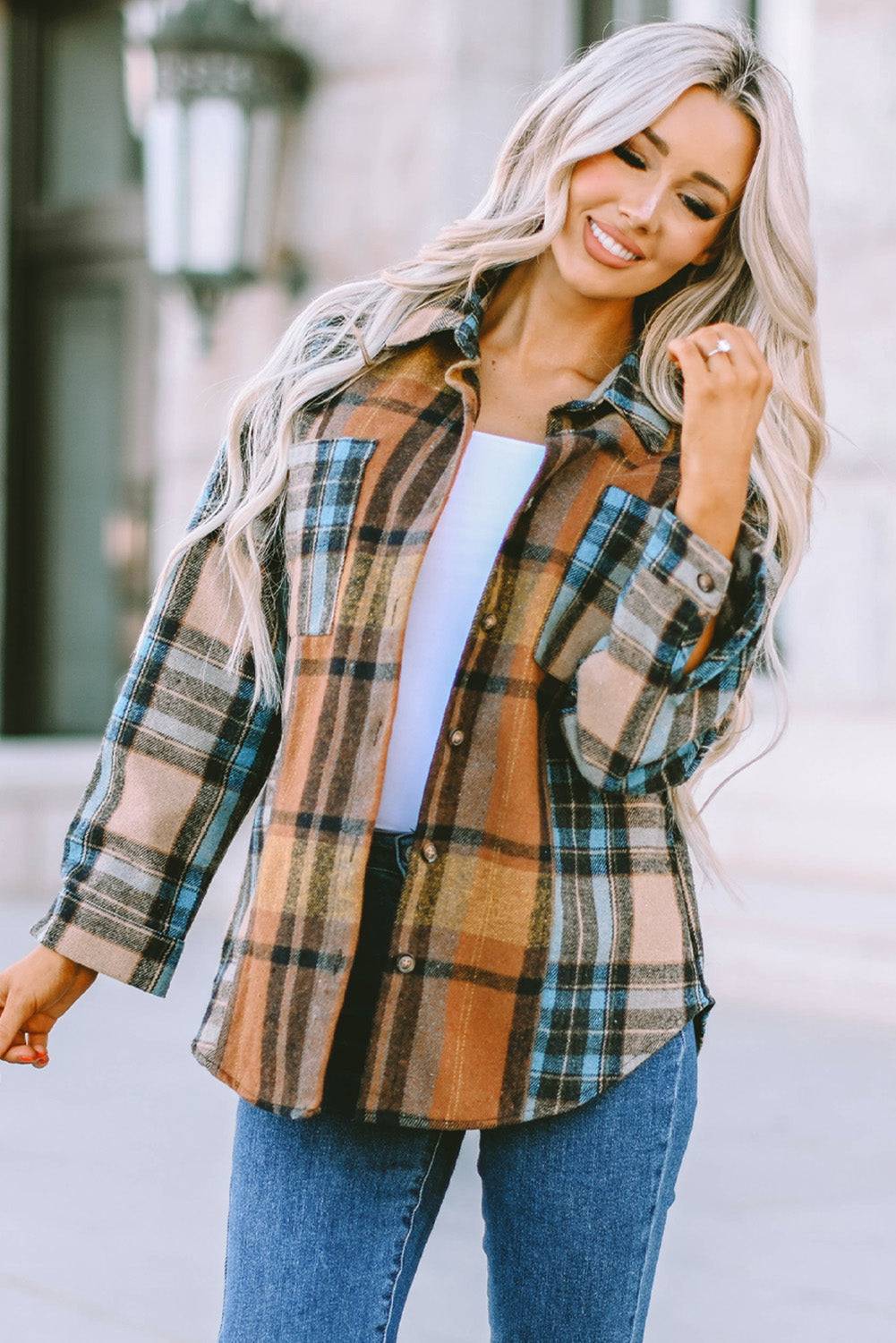 a woman wearing a plaid shirt and jeans