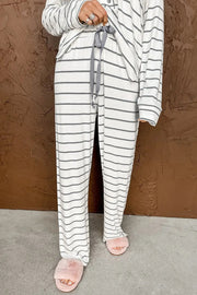 a person wearing a striped pajama and pink slippers