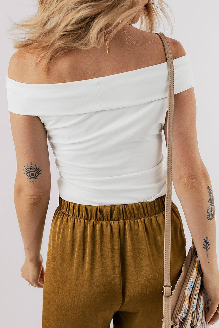 a woman with a tattoo on her arm holding a purse