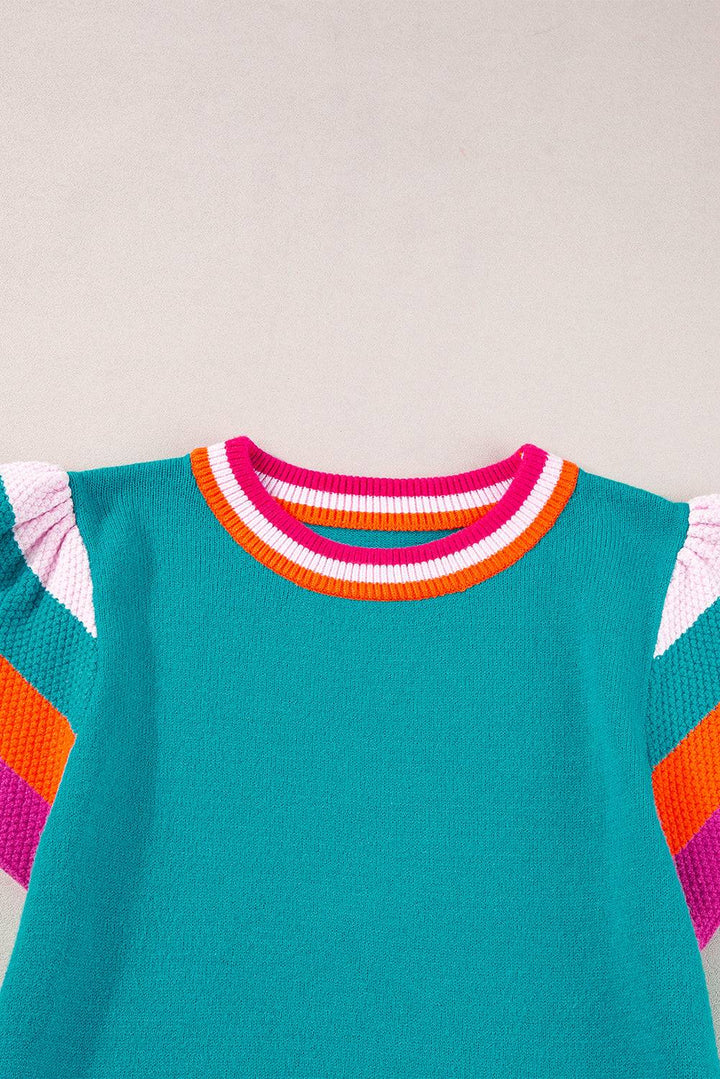 a green shirt with a pink, orange, and blue stripe