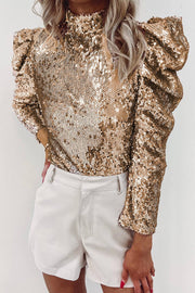 a woman wearing a gold sequin top