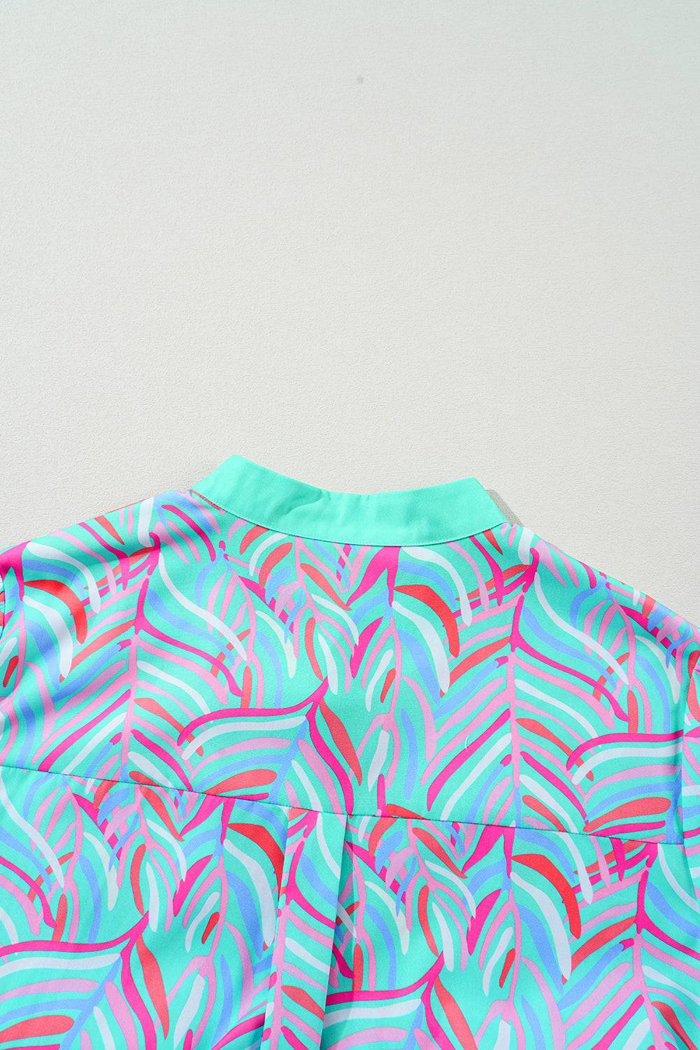 a blue and pink shirt with a pattern on it