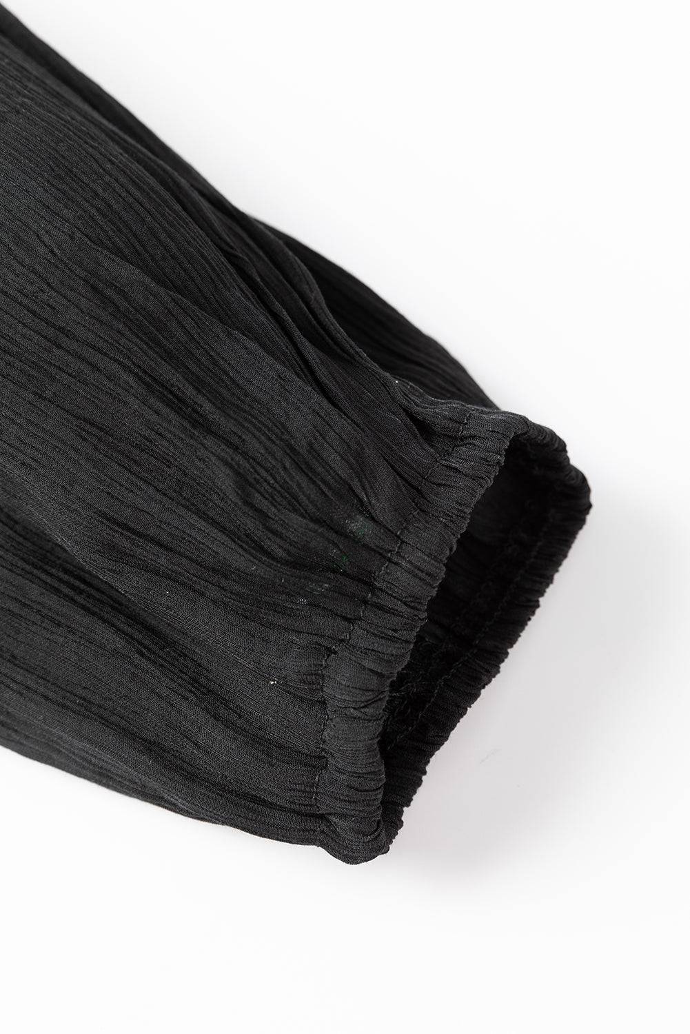 a black piece of cloth on a white surface