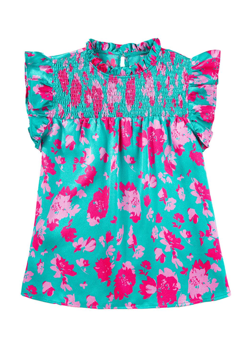 a girl's top with pink and blue flowers on it