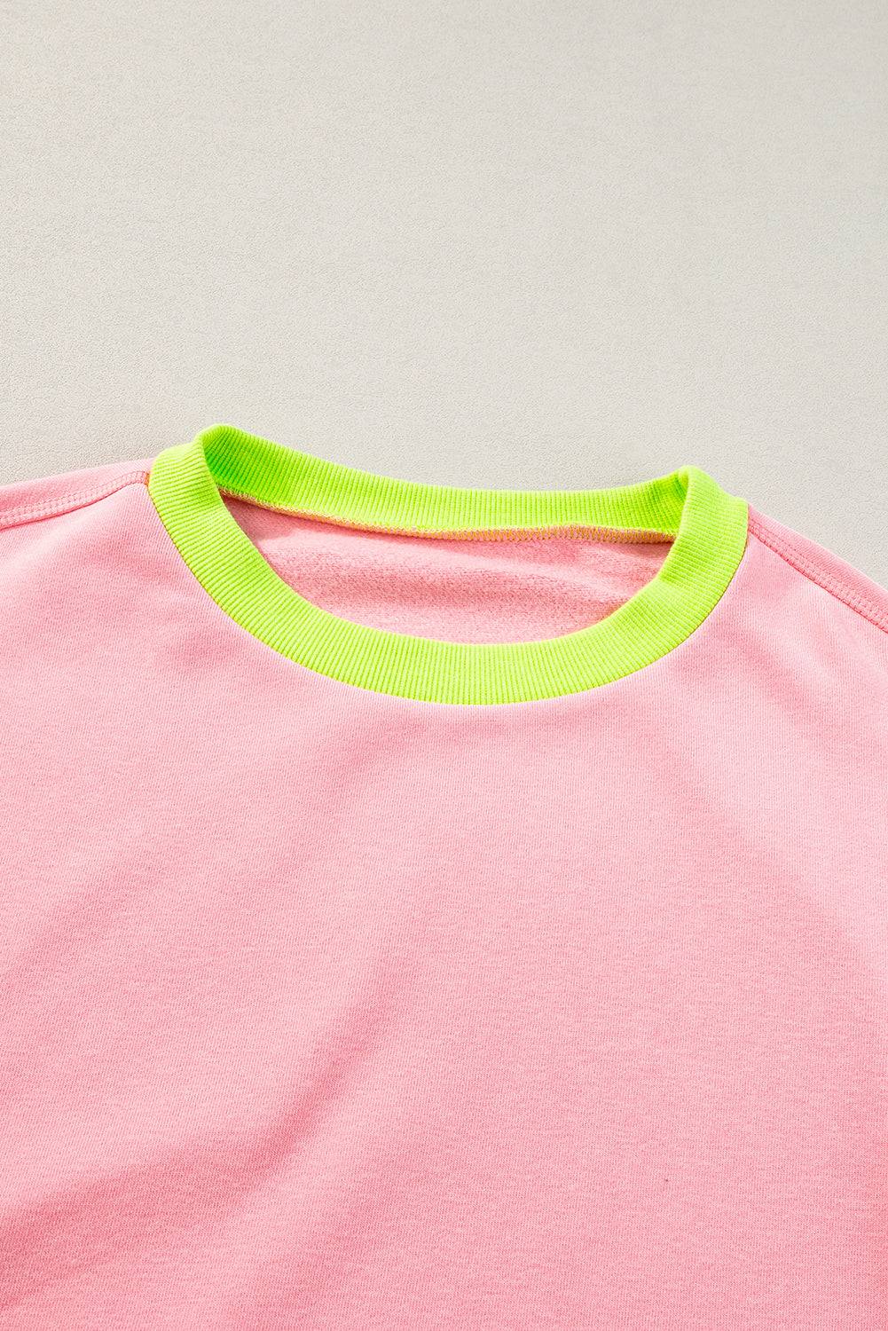 a pink t - shirt with neon yellow trim