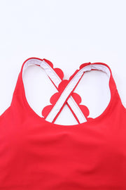 a woman wearing a red top with white straps