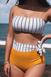 a woman in a bikini top and yellow shorts