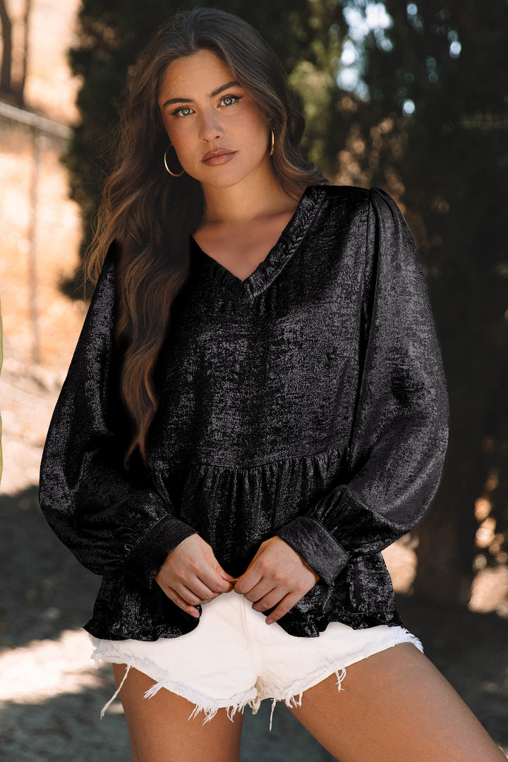 Black Metallic Frilled V Neck Puff Sleeve Babydoll Blouse from Faith & Co. Boutique, styled with white shorts for a bold seasonal look.