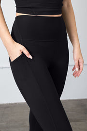 a woman in a black top and black leggings