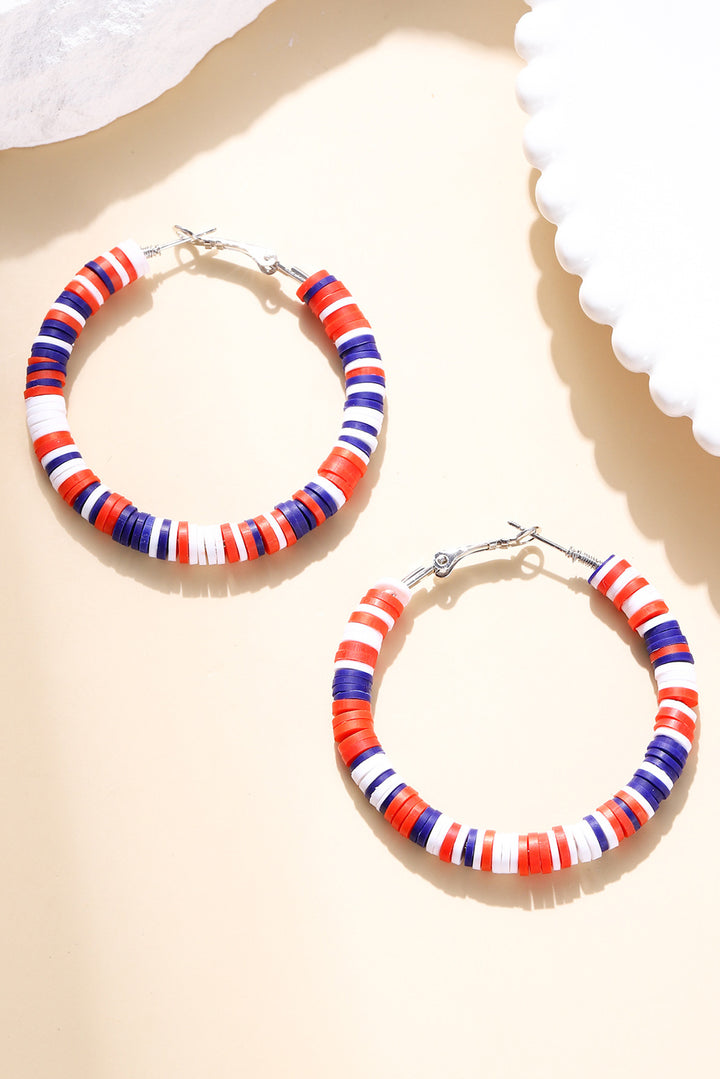 a pair of red, white and blue hoop earrings