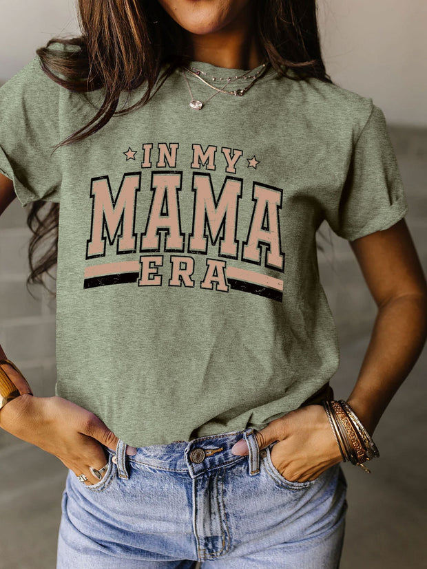a woman wearing a green shirt that says in my mama era