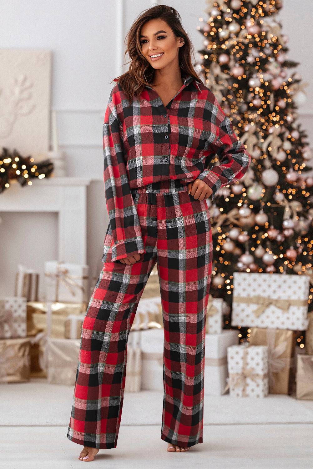 a woman standing in front of a christmas tree