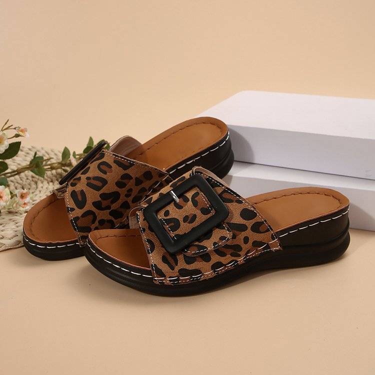 a pair of leopard print sandals sitting on top of a table