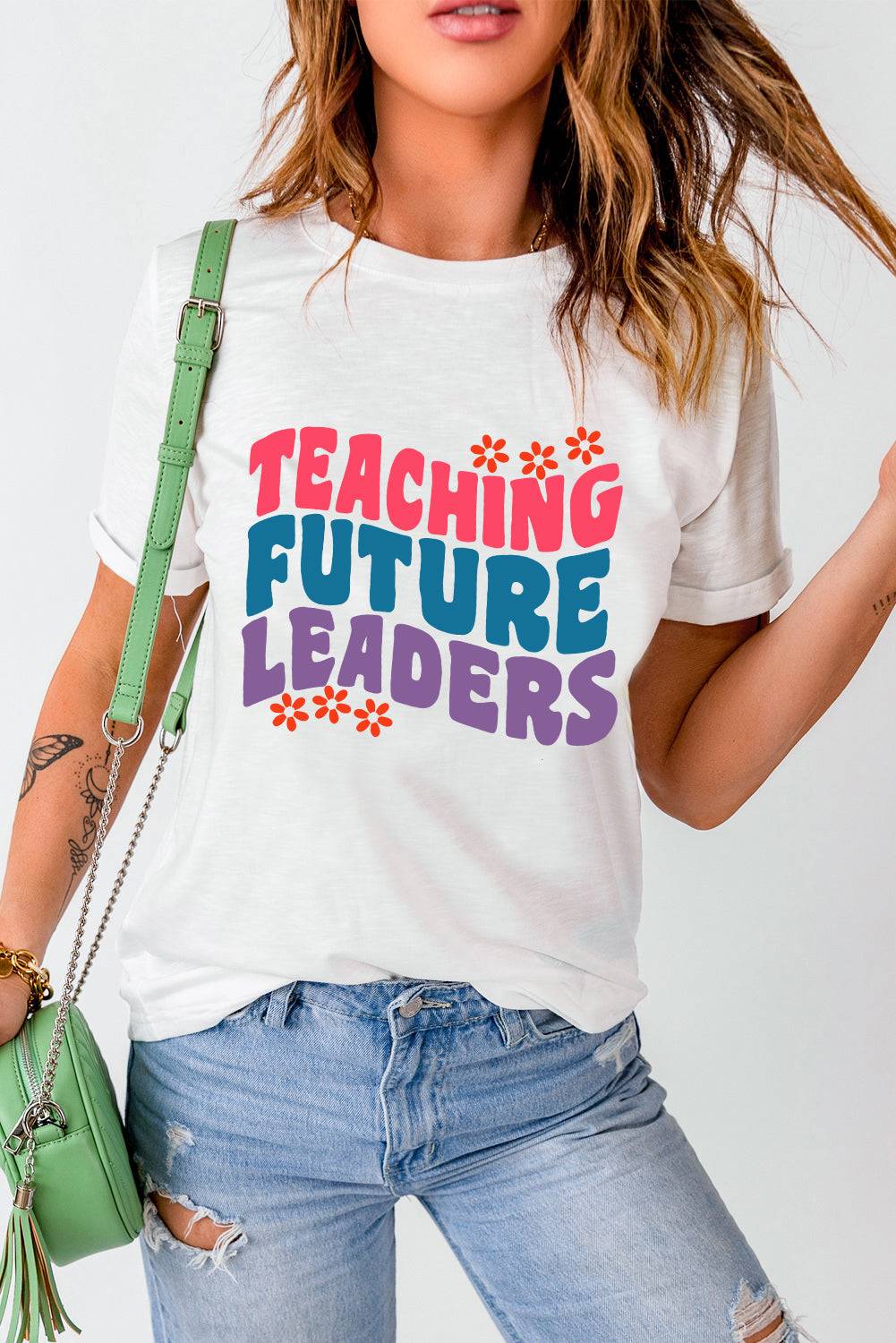 a woman wearing a t - shirt that says teaching future leaders