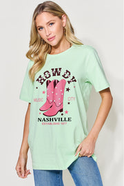 a woman wearing a green tee shirt with pink cowboy boots on it