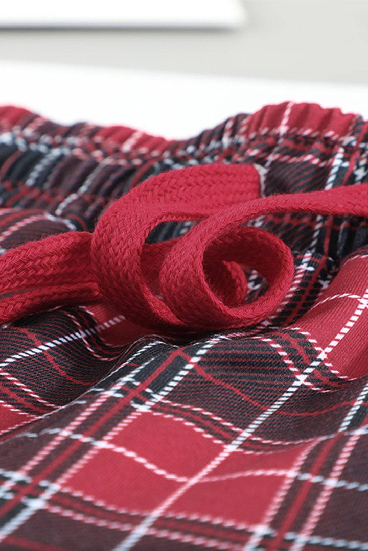 a close up of a red tie on a plaid shirt