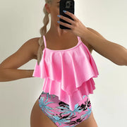 a woman taking a picture of herself in a pink swimsuit