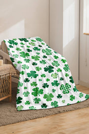 a green and white blanket with shamrocks on it
