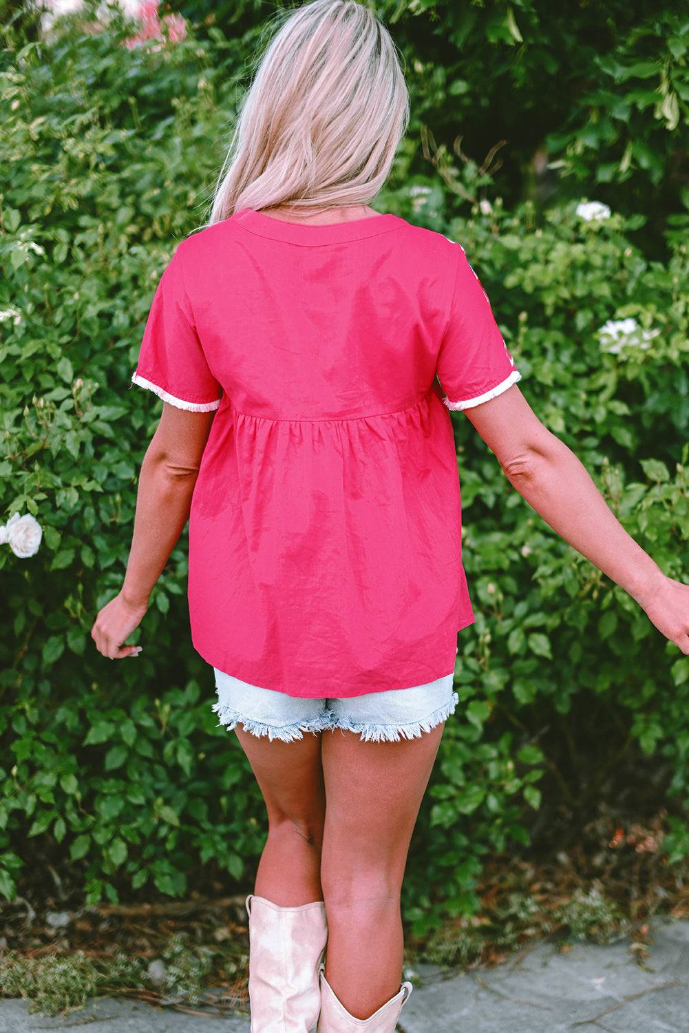 a woman in a pink shirt and white shorts