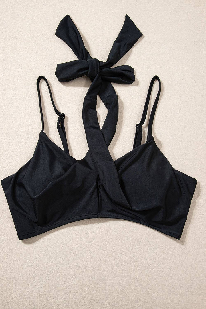 a black bikini top with a bow tied around it