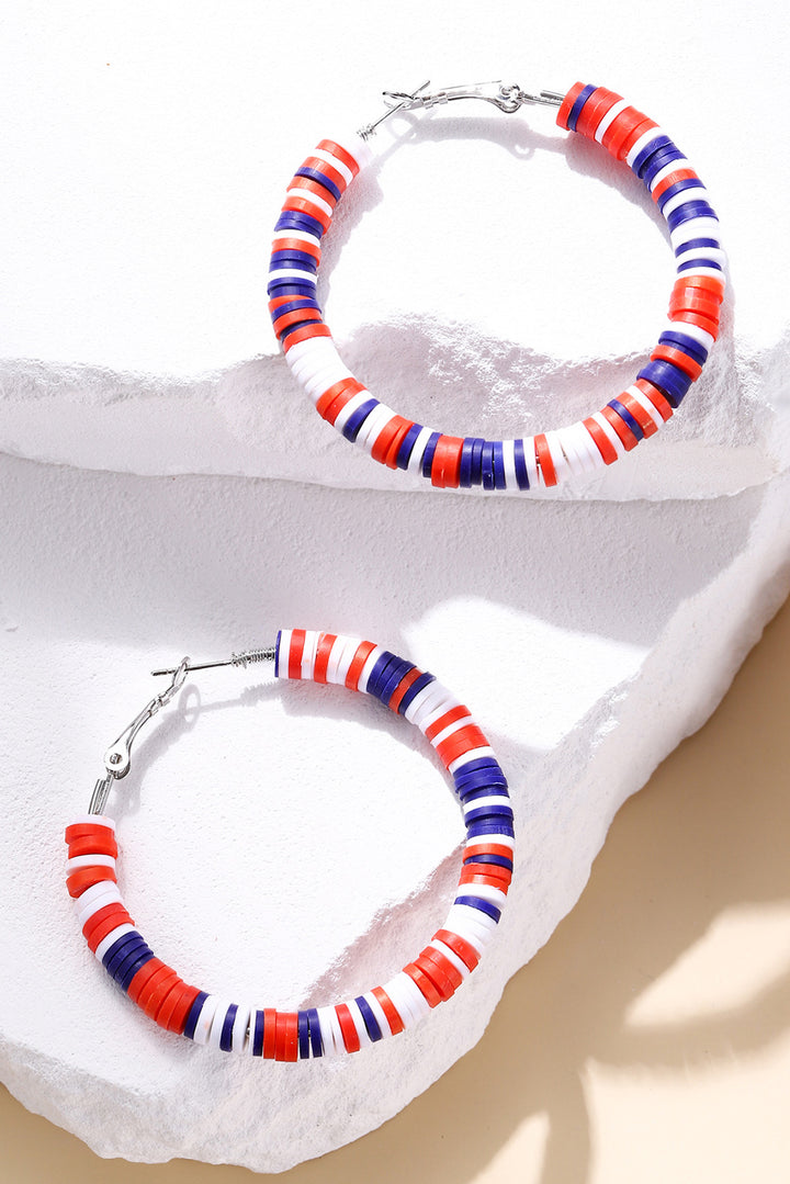 a pair of red, white, and blue beaded hoop earrings