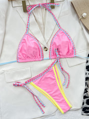 a woman's pink and yellow swimsuit and a white jacket