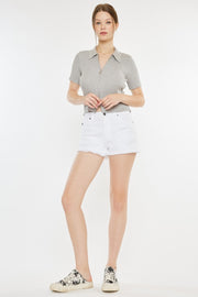 a woman in white shorts and a gray shirt