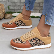 a woman wearing leopard print sneakers