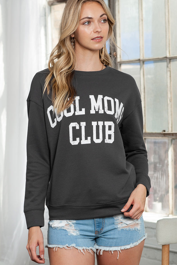 a woman wearing a black sweatshirt with the word collon club on it