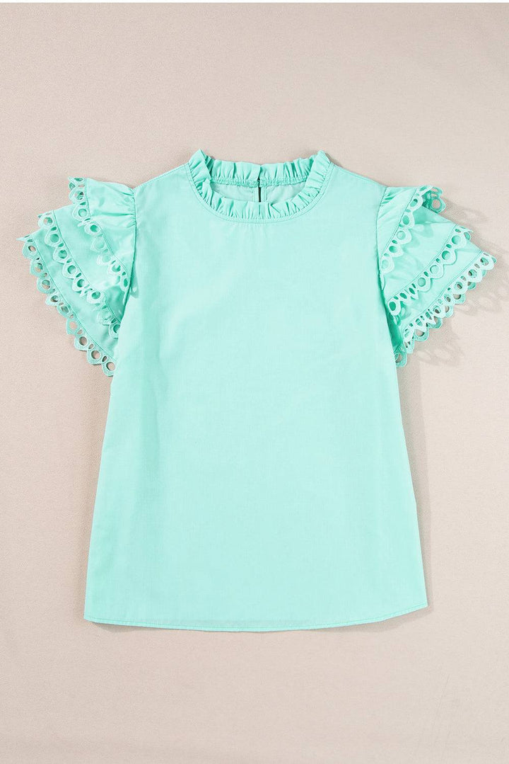 a baby girl's mint green top with ruffled sleeves