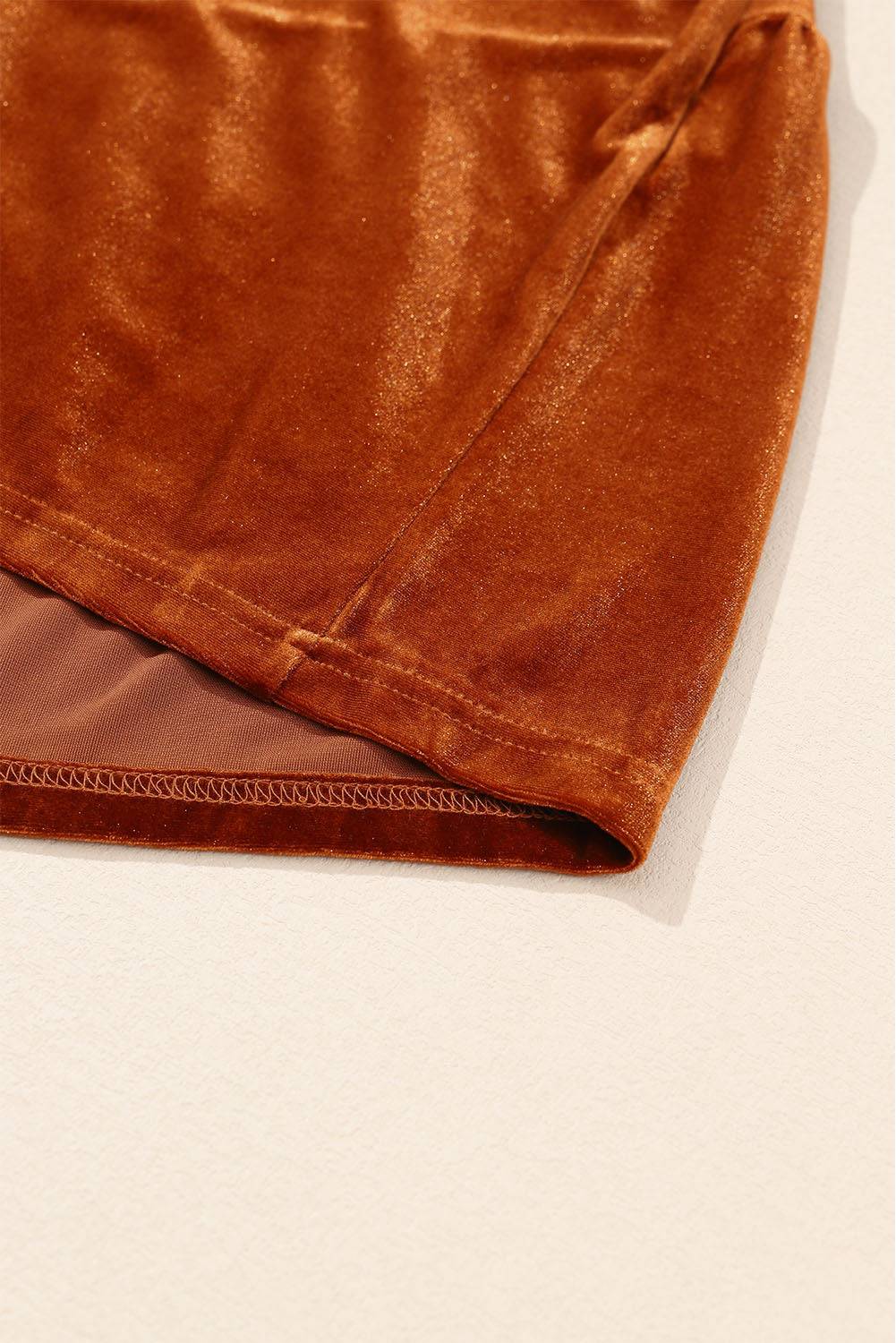 a pair of brown pants laying on top of a white surface