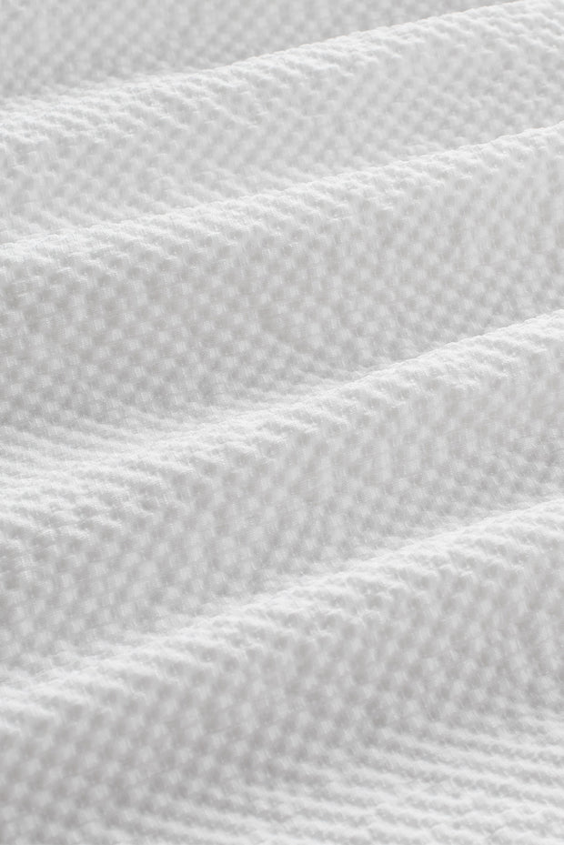 a close up of a white bed sheet