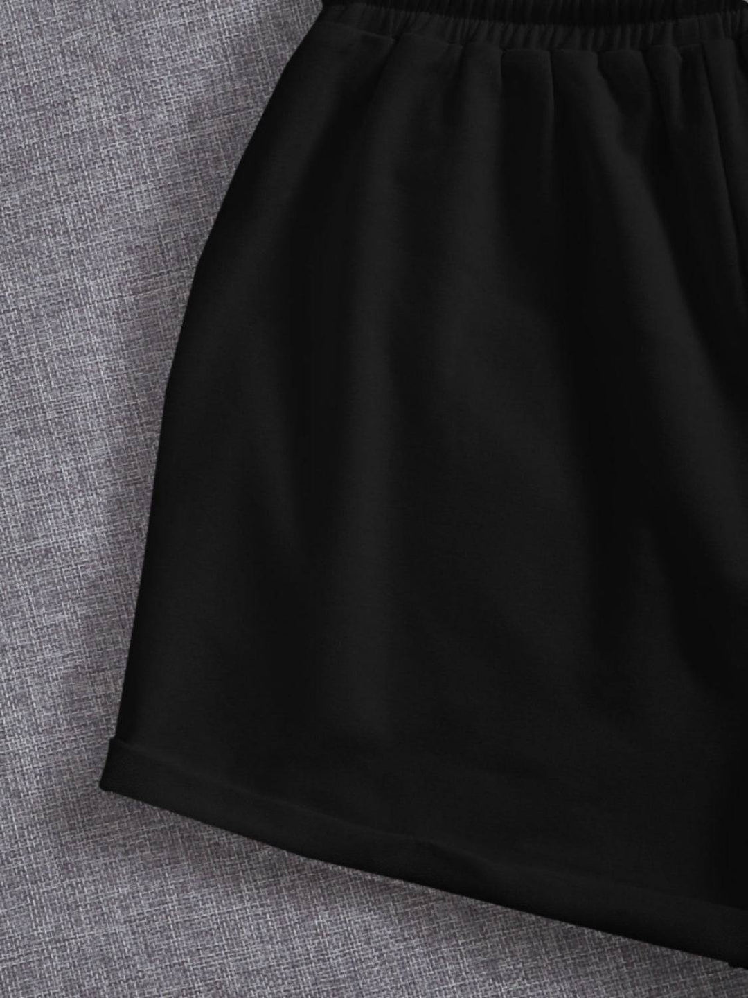 a close up of a black skirt on a gray background