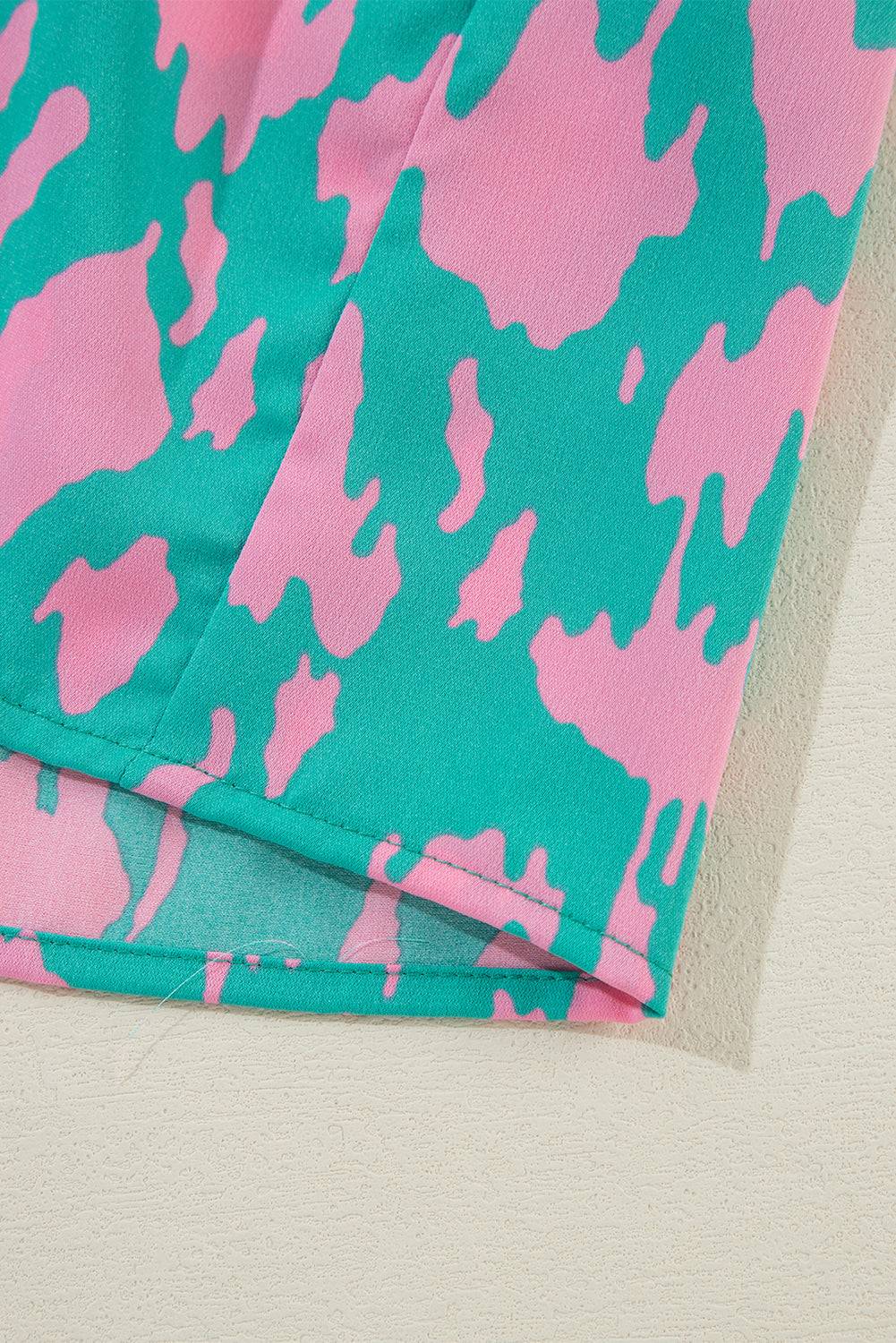 a close up of a pink and blue pattern on a pair of pants