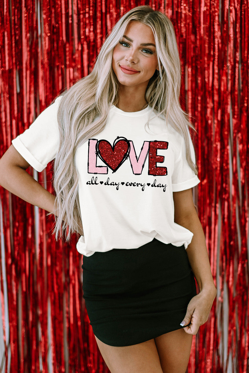 White Valentine LOVE Heart Shape Crew Neck Graphic Tee with red glitter heart and 'all day every day' text, styled with black mini skirt.