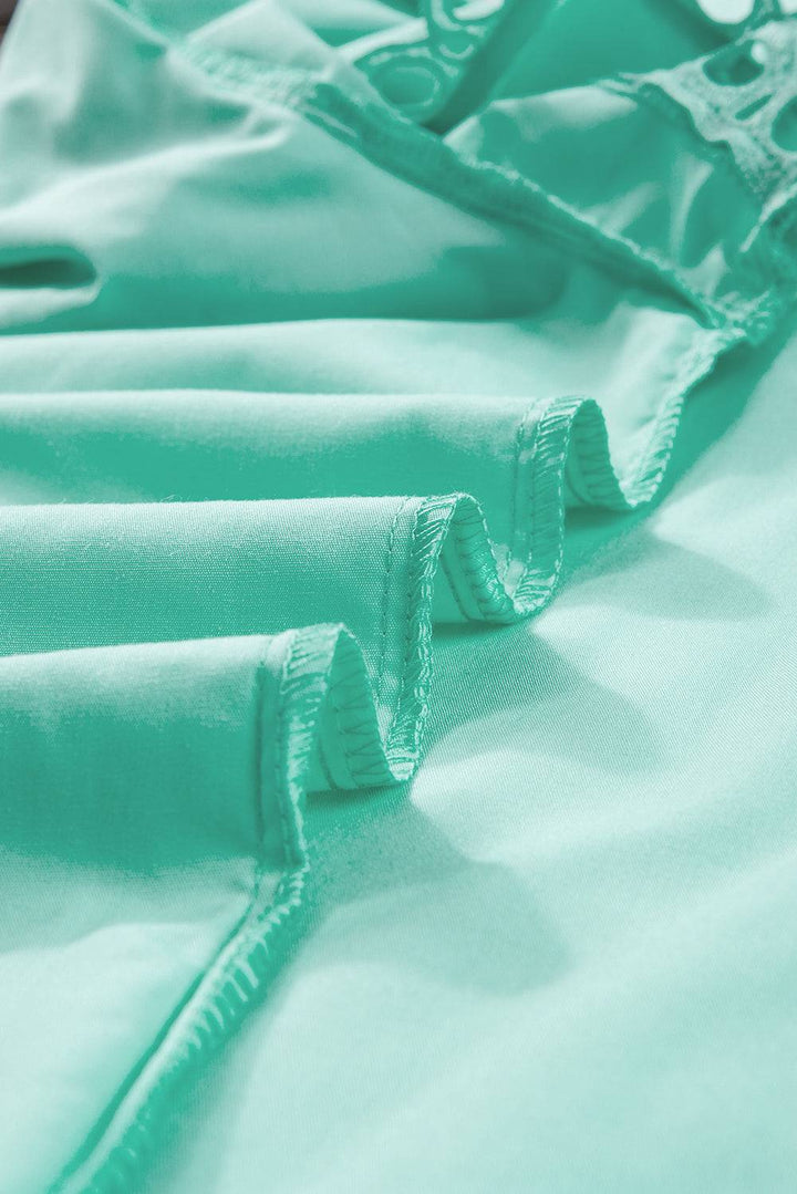 a close up of a bed with green sheets