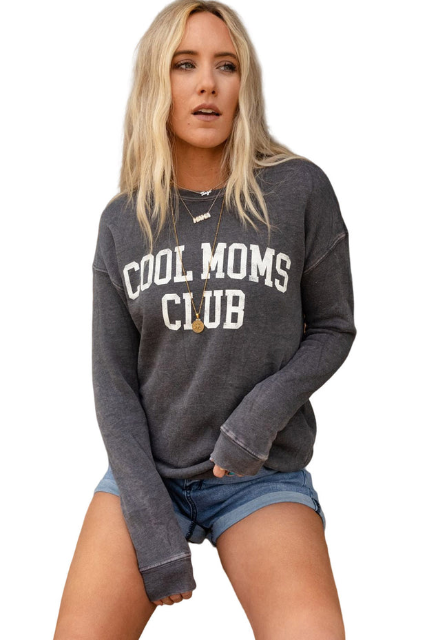 a woman wearing a sweatshirt that says cool moms club