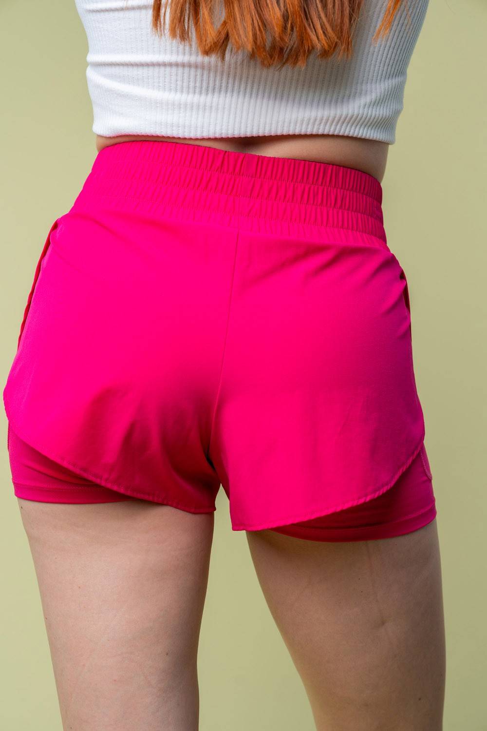 a close up of a person wearing pink shorts