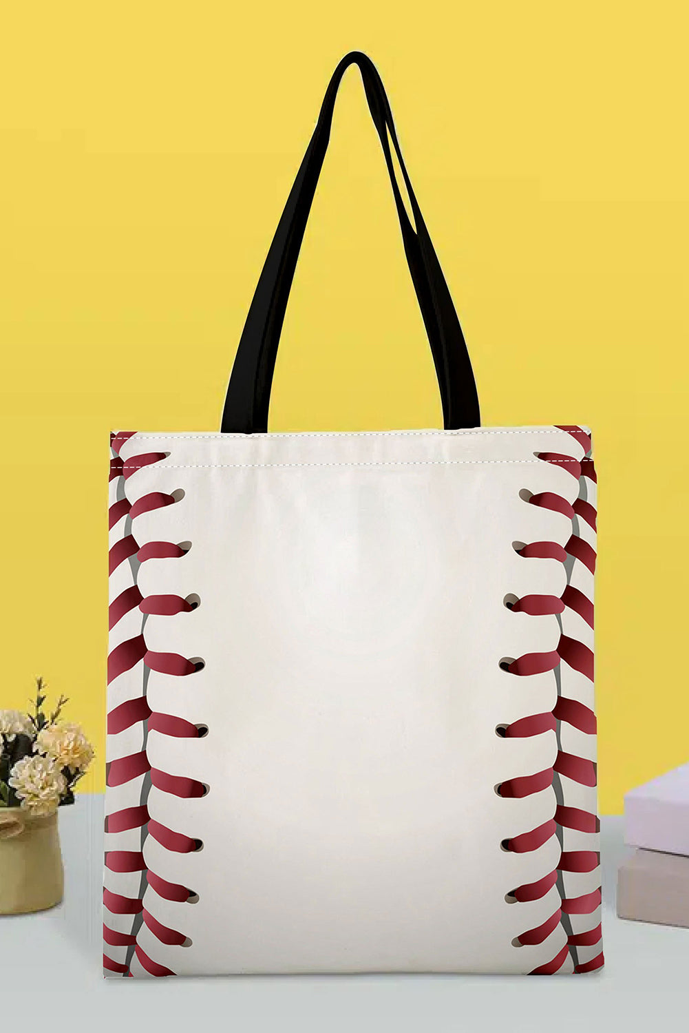 a white bag with red stitches on it