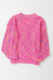 a pink sweater with multicolored dots on it