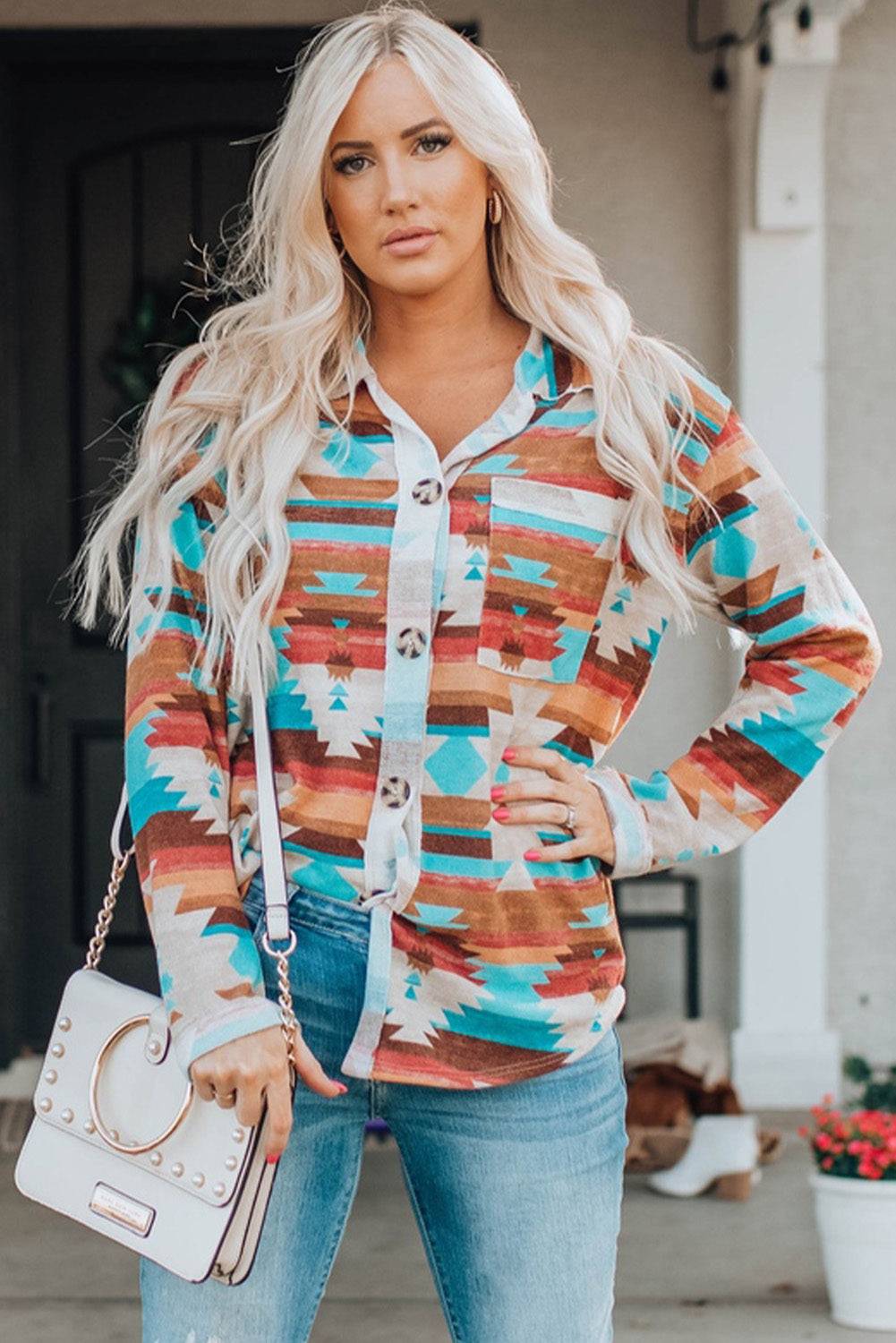 a woman wearing a colorful sweater and jeans