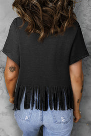 the back of a woman wearing a black top with fringes