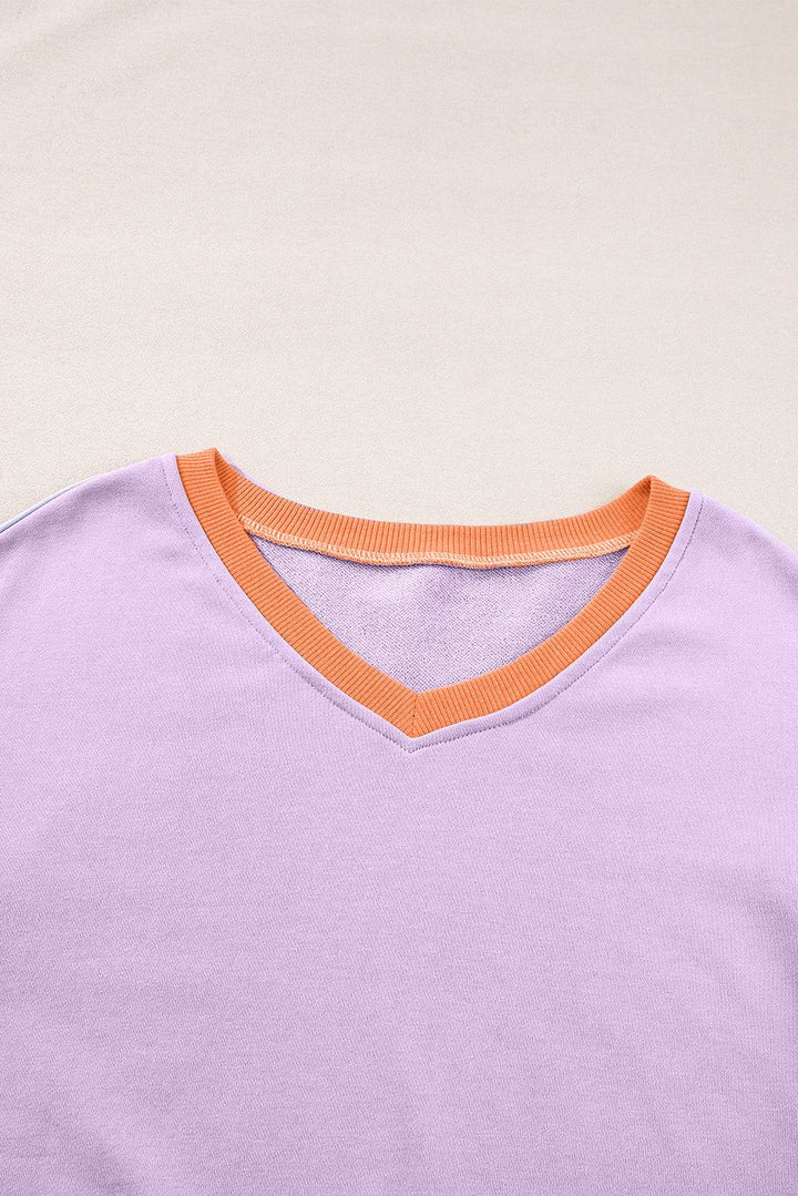 a purple shirt with an orange stripe on the chest