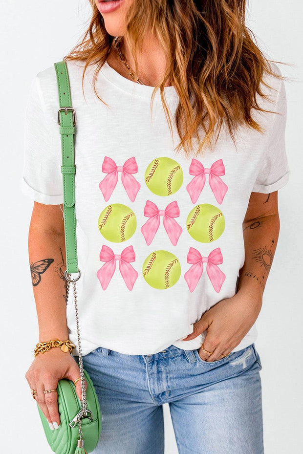 a woman wearing a t - shirt with a bow and softballs on it