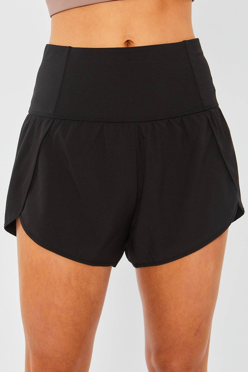 a close up of a woman's black shorts