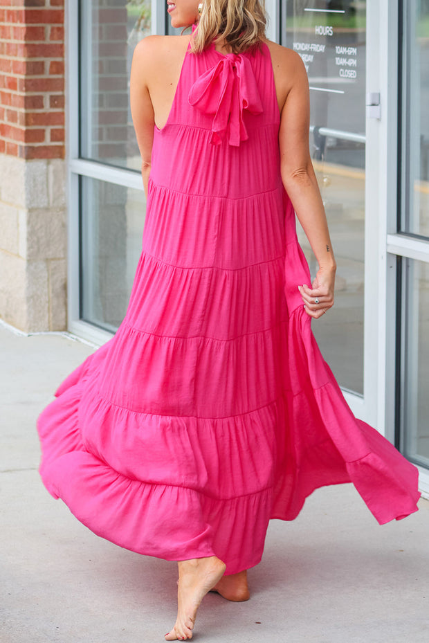a woman in a pink dress is walking down the street