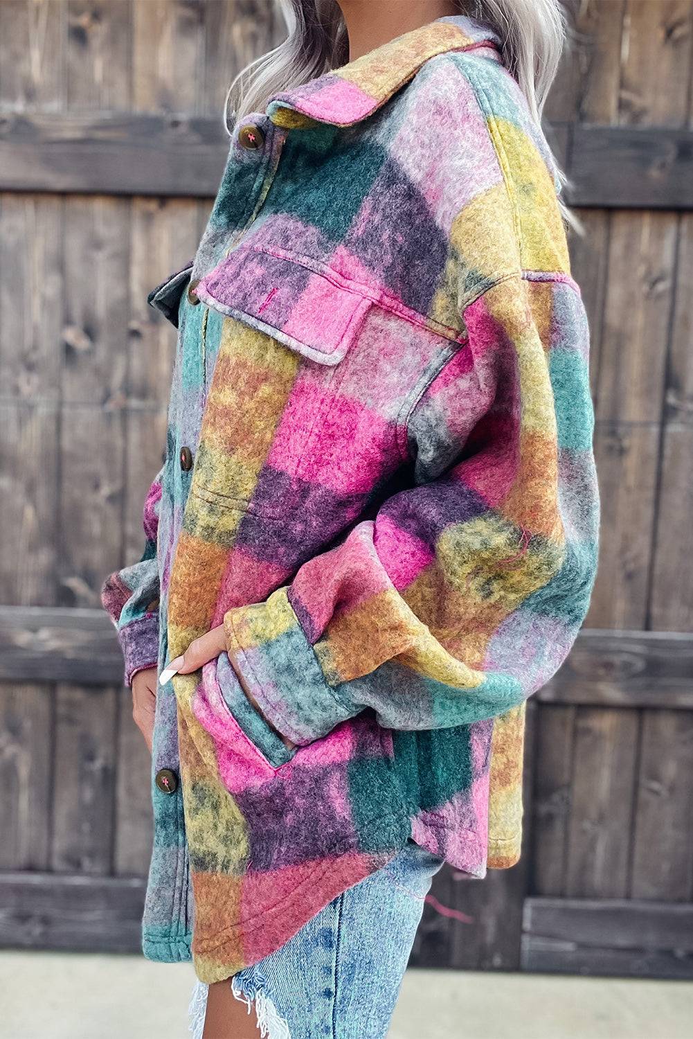 a woman wearing a multi colored jacket